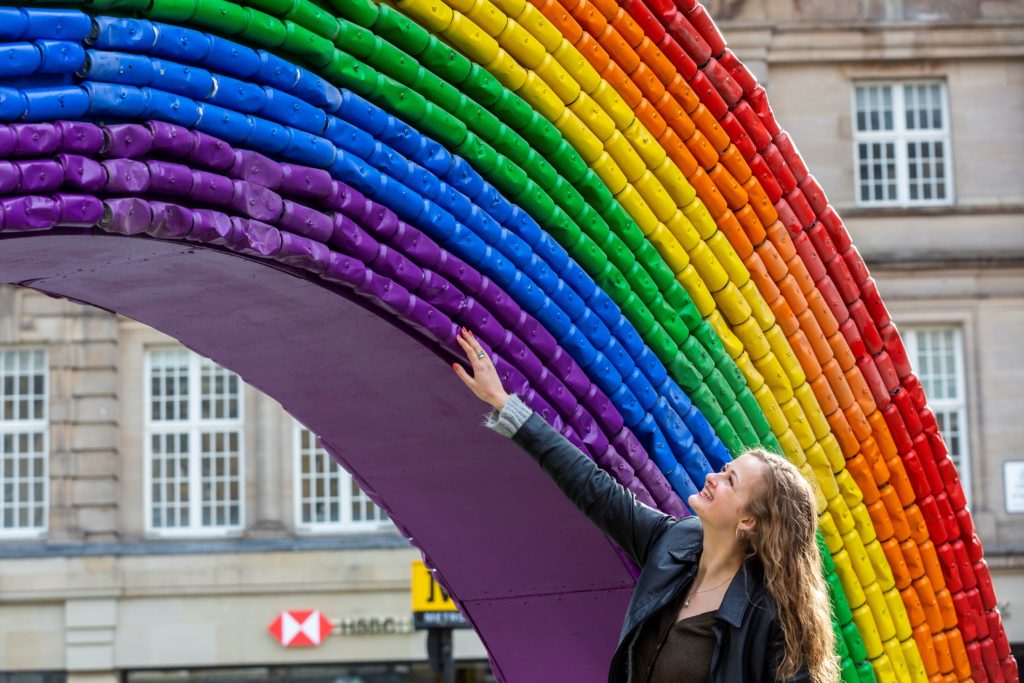 Photo of woman touching the The Every Can Counts Rainbow.